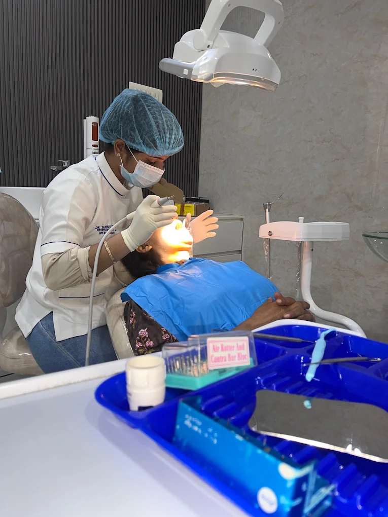 Dentist providing care to a patient at Dentoveda